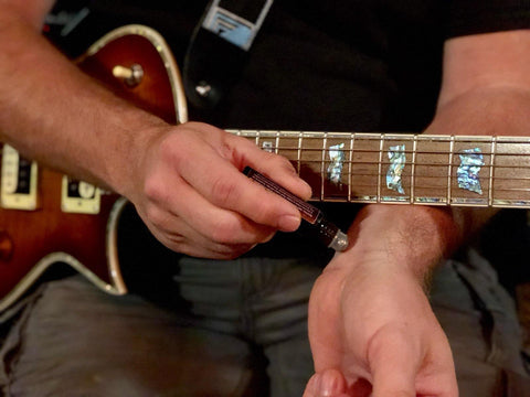 Man using Comfortably Numb® on his guitar playing wrist