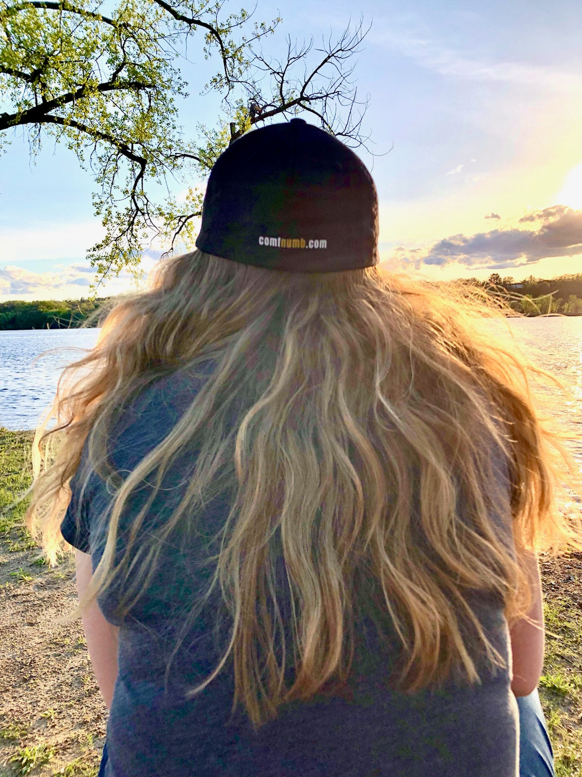 Watching the sunset by the St Croix River in Hudson, Wisconsin with a Cool Comfortably Numb baseball cap for women.